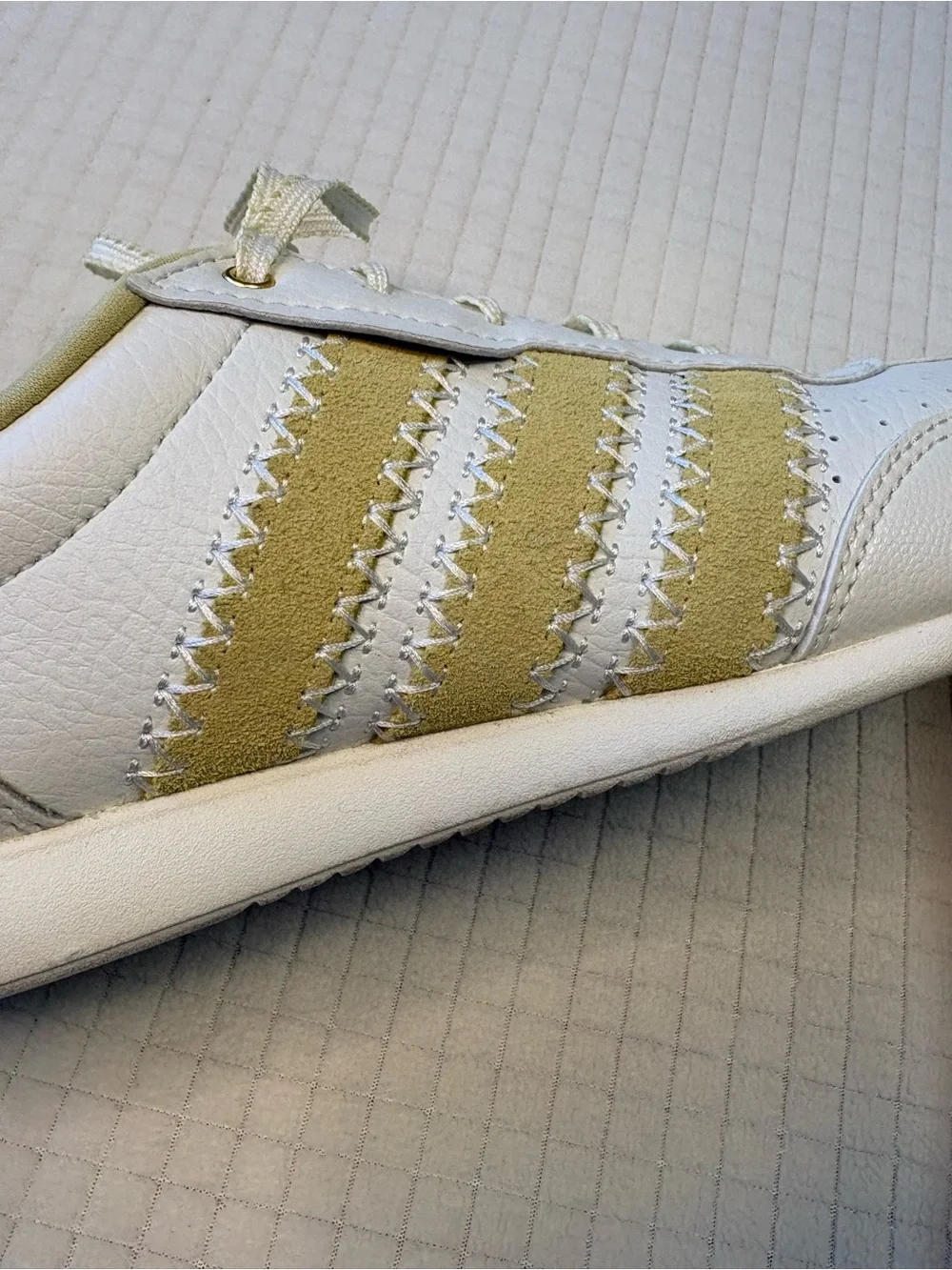 Adidas cream colored sneakers with floral accents
